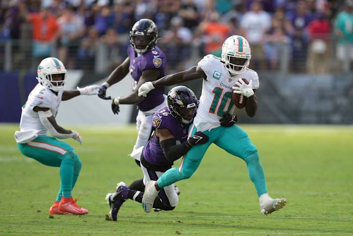 Miami Dolphins wide receiver Tyreek Hill (10) gains yardage after his catch in the fourth quarter defended by Baltimore Ravens safety Chuck Clark (36) at M&T Bank Stadium. Mandatory Credit: Mitch Stringer-USA TODAY Sports